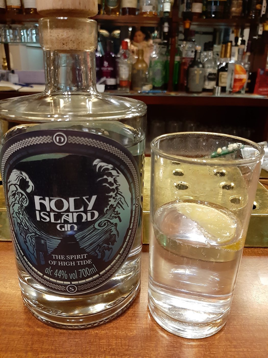 A bottle of Holy Island gin and a glass with ice