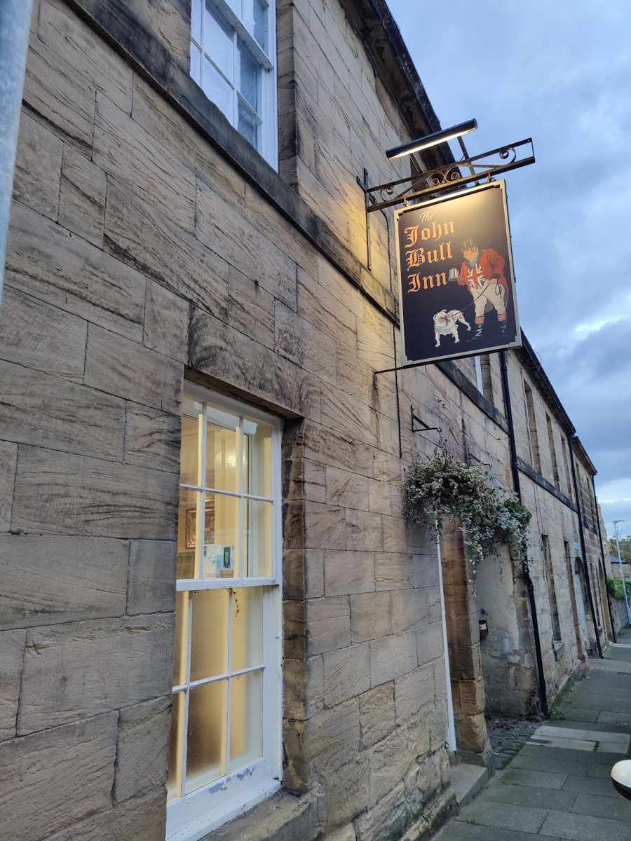 The stone terrace on Howick Street with the John Bull sign hanging by the door